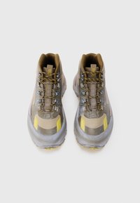 Gray and brown hiking shoes with yellow accents, textured surfaces, a sturdy design, and metal lace hooks for secure fastening.