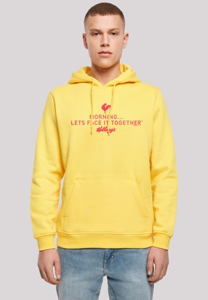 Yellow hooded sweatshirt with a kangaroo pocket, featuring pink text and a rooster graphic on the front. Soft cotton material, casual fit.