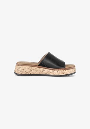Black leather slide sandal with cork platform sole and tan footbed, viewed from the side against a white background.