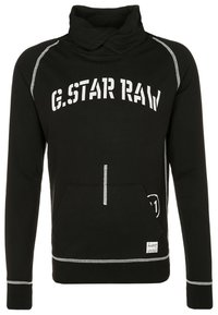 Sudadera con capucha negra y cuello alto, impresión blanca "G.STAR RAW", bolsillo frontal y detalles de costura blanca en contraste.