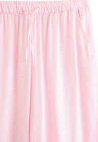 Lichtroze, geweven stoffen broek met een elastische tailleband, verstelbaar trekkoord en zijzakken. Gladde textuur, relaxte pasvorm.