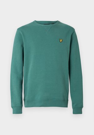 Sweat-shirt turquoise avec un col ras du cou et des poignets côtelés. Présente un logo jaune brodé sur la poitrine. Tissu en coton lisse.