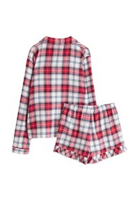 Ensemble de pyjama à carreaux rouges et blancs comprenant un haut à manches longues avec col et un short assorti avec des ourlets volantés. Matériel en coton.