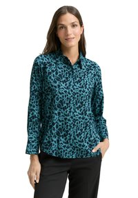 Türkisfarbenes Hemd zum Knöpfen mit einem schwarzen Leopardenmuster, langen Ärmeln und einem strukturierten Kragen. Weicher Stoff mit leichtem Glanz.