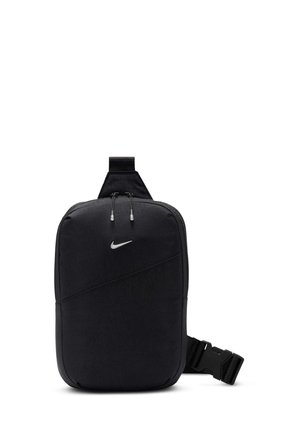 Sac bandoulière compact noir Nike avec logo argenté, compartiment principal zippé et sangle ajustable avec fermeture à boucle en plastique.