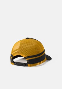 Yellow mesh trucker cap with black adjustable snapback strap and black brim, shown from a slight rear angle on a white background.