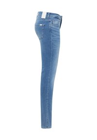 Jeans in denim azzurro slim-fit viste di lato con tasche frontali e posteriori e un'etichetta bianca visibile sulla vita.