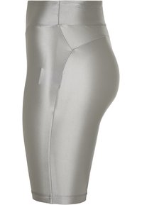 Grå sträckbyxor med en slät yta, hög midja och knälång design. Har kontrastsömmar och en sidficka.