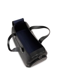 Black duffel bag with a textured exterior and smooth black handles. Interior is navy blue with a spacious compartment and a zippered closure.