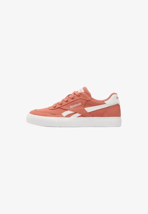 Sneaker Reebok bassa in rosa corallo con strisce laterali bianche e suola in gomma, vista dal lato esterno.
