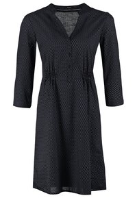 Robe noire longueur genou à petits pois blancs, manches trois-quarts, col en V et taille froncée.