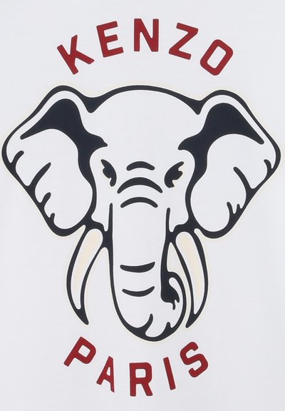 Chemise blanche ornée d'un graphisme d'éléphant noir et beige, avec "KENZO" en arc rouge au-dessus et "PARIS" en rouge en dessous de l'éléphant.