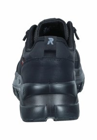 Baskets de sport noires avec une tige texturée, un col rembourré et une languette. Elles disposent d'une semelle en caoutchouc épaisse avec un motif de traction.