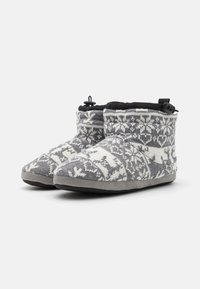 Gray and white knit slippers with a reindeer pattern, soft fabric upper, padded black collar, and gray rubber sole.