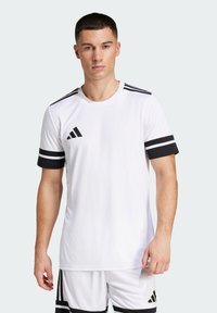 White athletic t-shirt with black accents, featuring three black stripes on shoulders and striped black cuffs. Includes logo on the chest.