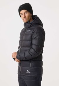 Black puffer jacket with a hood, featuring a front zipper, side pockets, and "Premium Down" logo. The material has a smooth texture.