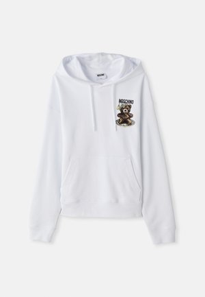 Hoodie blanc avec une poche avant, capuchon à cordon de serrage, et un graphique d'ours accompagné de texte. Fabriqué à partir d'un tissu doux, il dispose de poignets et d'un ourlet côtelés.