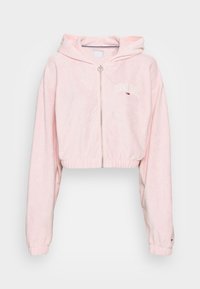 Roze cropped hoodie met rits, gemaakt van zachte stof. Voorzien van een capuchon, lange mouwen en een geborduurd "TOMMY JEANS"-logo. Ritssluiting aan de voorkant.