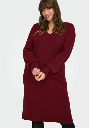 Burgundské pletené šaty s výstřihem do V, dlouhými rukávy a ribbed manžetami. Středně dlouhý design s volným střihem a bočními rozparky na lemu.