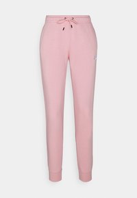 Pink cotton jogger pants with elastic waistband and drawstring. Features tapered legs and a small Nike logo on the left side.