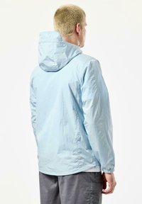Light blue nylon jacket featuring a hood, elastic cuffs, and a slightly textured finish. Back view with a relaxed fit and minimal design details.
