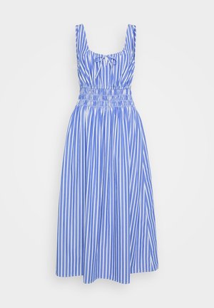 Abito a righe blu e bianche con un corpetto aderente, spalline larghe e vita elasticizzata. La gonna scorre fino al ginocchio. Materiale in cotone.