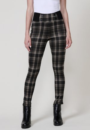 Pantaloni a quadri neri e grigi con un design aderente, vita alta con due bottoni e zip alla caviglia. Tessuto dalla texture liscia.