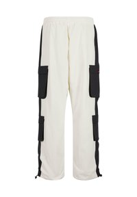 White cargo pants with black side accents, featuring multiple front pockets, elastic waistband, and adjustable cuffs at the hem.