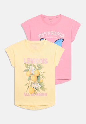 Geel T-shirt met citroenen en de tekst "LEMONS ALL SUMMER" over een roze T-shirt met een blauwe vlinder en de tekst "BUTTERFLY SUMMER CLUB".