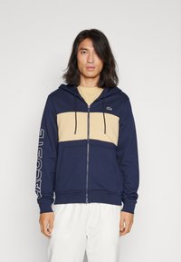 Lacoste - ZIPPED COLOURBLOCK HOODIE UNISEX - Majica s kapuljačom i patentnim zatvaračem - navy blue/croissant Minijatura 1