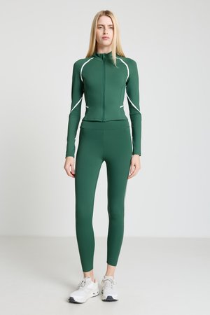 Green athletic set made of stretchy material. Features a zip-up jacket with white trim and matching fitted leggings. Includes white accents.