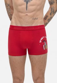 Boxer shorts de algodón rojos con un ajuste ce�ñido, cinturilla con la inscripción "XMAS" y un estampado gráfico de regalos con el texto "NO SOY UN Santa".