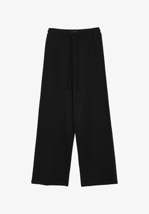 Schwarze weite Hosen aus weichem Stoff mit einem elastischen Bund und Zugband sowie genähten Details an den Seiten.