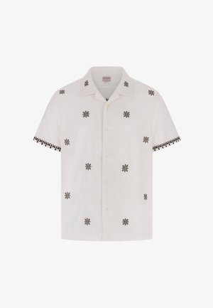 Witte blouse met korte mouwen, zwart symmetrisch bloemenpatroon verspreid en een patroonrand aan de mouwuiteinden.