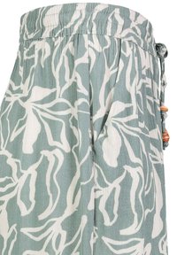 Light green pants with white botanical print, featuring an elastic waistband and drawstring with wooden accents. Textured fabric design.