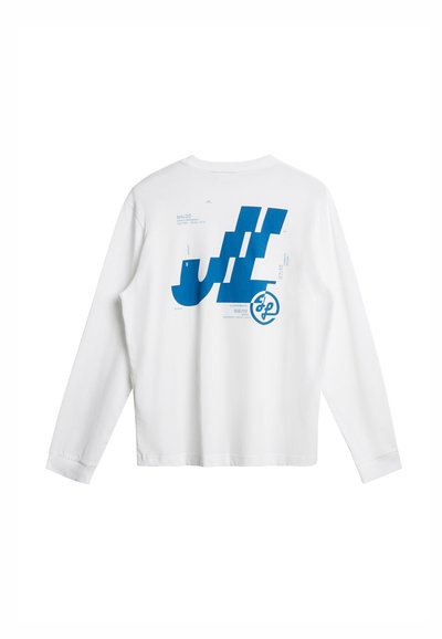 Λευκό πουκάμισο με μακριά μανίκια, με μεγάλο μπλε αφηρημένο λογότυπο και μικρό κείμενο τυπωμένο στο πάνω μέρος της πλάτης.
