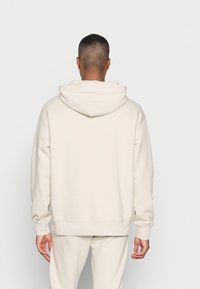 Fila Jersey con capucha - sand