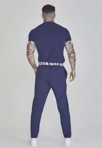 SIKSILK TAPERED FIT JOGGERS - Tracksuit bottoms - navy