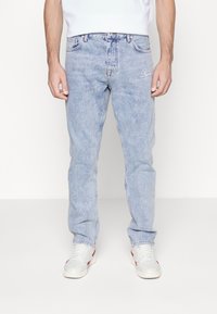 Ljusblå denimjeans med rak passform, som har en diskret logobroderi framtill. Tyget har en mjuk, urtvättad textur.