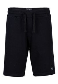 Schwarze Baumwollshorts mit einem elastischen Bund, Kordelzugverschluss und einem Patch-Logo am unteren Bein. Glatte Textur, knielanges Design.