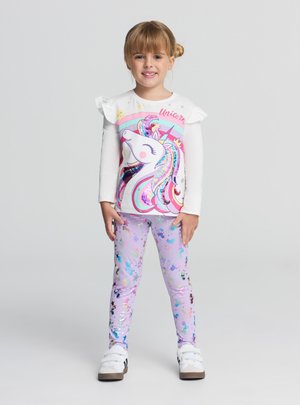 Maglietta bianca a maniche lunghe con spalle arricciate e una colorata grafica di unicorno, abbinata a leggings viola con motivi di stelle multicolori.