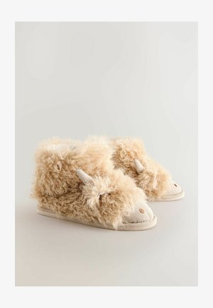 Karvased beežid beebijalatsid, millel on loomafassaad, kõrvad ja tikitud nina, paigutatuna lihtsa heleda tausta peale.