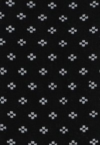 Czarny materiał o teksturowanej powierzchni, z powtarzającym się wzorem małych białych kształtów kwiatowych ułożonych w formacie siatki.