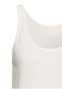 Crème-kleurige mouwloze tanktop van textuurgebreide stof, met een ronde halslijn en zachte, ademende stof.