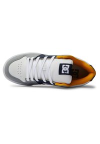 White and gray sneaker with a textured upper, navy accents, and yellow lining. Features white laces and perforations on the toe area.