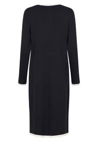 Černé šaty s dlouhým rukávem a přímým střihem, s bílými akcenty na výstřihu a manžetách rukávů. Hladká textura, délka po kolena.