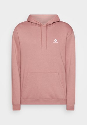 Różowa bluza Converse z kapturem, przednią kieszenią kangurka, sznurkiem do regulacji kaptura oraz małym białym logo Converse na piersi.