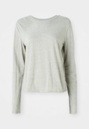 Lichtgrijs shirt met lange mouwen, gemaakt van zachte stof, met een ronde halslijn en een relaxte pasvorm. Naaddetails langs de zijkanten.