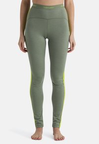 Groene leggings met een strakke pasvorm, met een hoge tailleband en neongele zijstrepen. Gemaakt van zachte, gestructureerde stof.