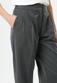 Gray tailored pants made of textured fabric, featuring side pockets and front pleats, with a fitted waistband and straight leg design.